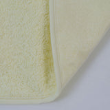 Plastic terry bib with yellow rubber