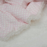 Polka dot blanket + pink stuffed rabbit