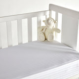 Crossed mattress cover for crib
