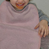 Pack of 3 terry cloth bibs for daycare in pale pink with elastic Washable, terry cloth exterior and waterproof backing Dimensions: 33x29cm